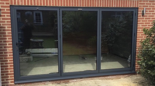 Schuco ASS70FD bi fold doors with flush floor decking to the outside